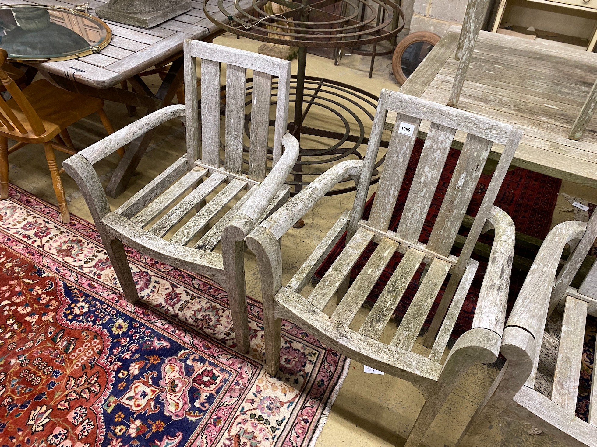A weathered teak extending table, length 150cm, 90cm unextended and six teak chairs